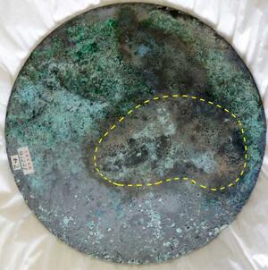 　富雄丸山古墳から出土した銅板と痕跡（点線部分）が一致した三角縁神獣鏡（天理大付属天理参考館提供）