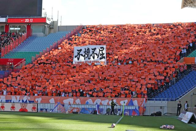 試合前、新潟サポーターが掲げる紙でオレンジ色に染まったスタンド=12月8日、さいたま市